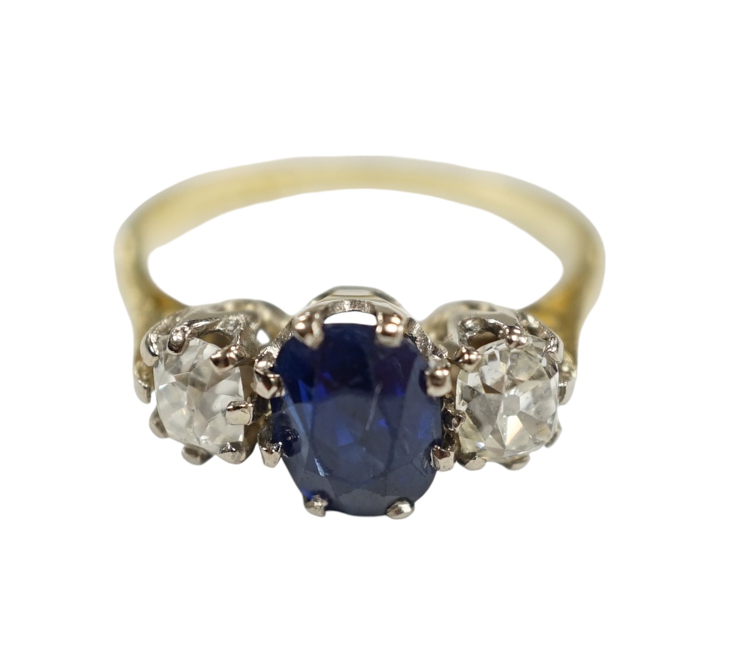 A late 1970's 18ct gold, sapphire and diamond set three stone ring, size J/K, gross weight 3.8 grams. Condition - fair